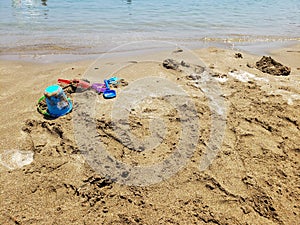 Sand texture. Sandy beach for background. Child toys. Top view