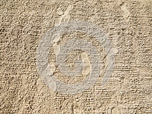 Sand texture. Sea sand bottom with footprints