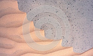 Sand textures background on the beach on a grey basis