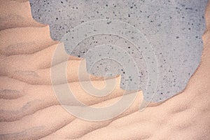 Sand textures background on the beach on a grey basis