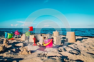 Sand toys and castle on tropical beach, kids play on sea vacation