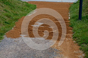 Sand wheeling. garden wheelbarrow carries a worker and pours on piles of beige gravel to repair park, forest, dirt road. erosion c