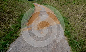 Sand wheeling. garden wheelbarrow carries a worker and pours on piles of beige gravel to repair park, forest, dirt road. erosion c