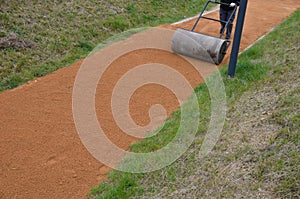 Sand wheeling. garden wheelbarrow carries a worker and pours on piles of beige gravel to repair park, forest, dirt road. erosion c