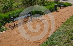 Sand wheeling. garden wheelbarrow carries a worker and pours on piles of beige gravel to repair park, forest, dirt road. erosion c