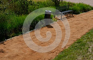 Sand wheeling. garden wheelbarrow carries a worker and pours on piles of beige gravel to repair park, forest, dirt road. erosion c