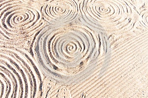 the sand is really white and circular circles are in the sand