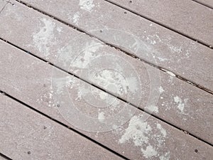 Sand on a wood deck