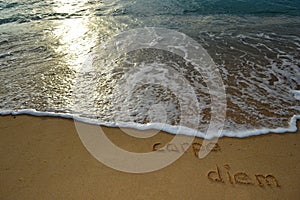 Sand writing 'carpe diem'