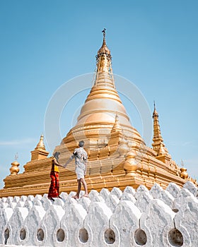 Sanda Muni Paya Mandalay Myanmar, young couple on vacation in Myanmar walking by temple