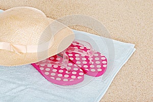 Sandals hat on a beach towel