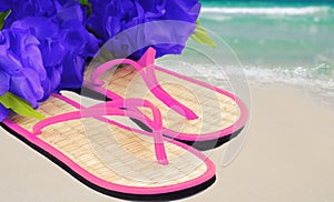 Sandals and lei on beach