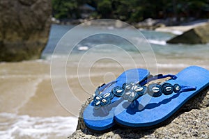 Sandals on a rock at the beach