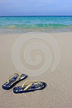 Sandals on a tropical sandy beach