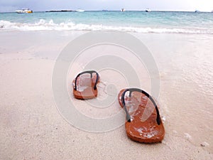 Sandals on white beach