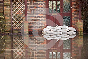 Sandbags Outside Front Door Of Flooded House