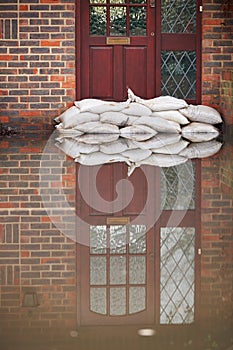 Sandbags Outside Front Door Of Flooded House