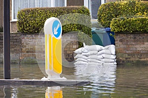 Sandbags Outside House On Flooded Road photo