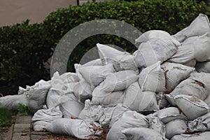 Sandbags stacked in front of foliage