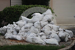 Sandbags stacked in front of foliage