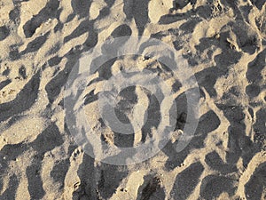 Sandbeach sand with hidden child footprint