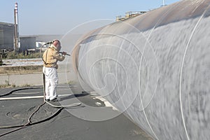 Sandblasting or abrasive blasting to steel material. Abrasive blasting, which uses compressed air to clean surfaces. photo