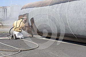 Sandblasting or abrasive blasting to steel material. Abrasive blasting, which uses compressed air to clean surfaces. photo