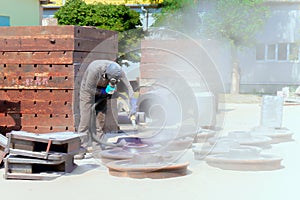 Sandblasting at an industrial plant, a worker knocks down oxide