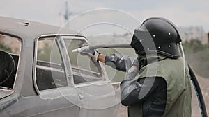 Sandblasting of metal surface of the car by compressed air of the sandblaster gun