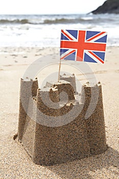 Sandcastle On Beach With Union Jack Flag