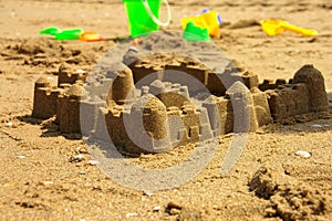 Sandcastle and children toys at a beach