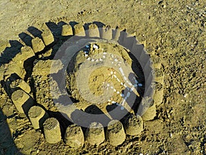 a sandcastle with shells on the beach