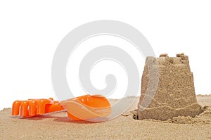 Sandcastle, shovel and rake