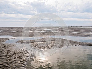 Sandflats at low tide of tidal sea Waddensea near Boschplaat, Te photo