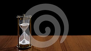 Sandglass measuring time by sand flow, life passing quickly, time management