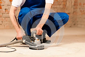 Sanding the cement floor
