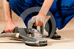 Sanding the cement floor