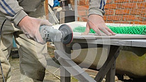 sanding down the edges of finishing tiles photo