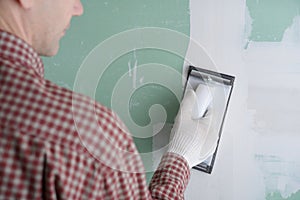 Sanding the drywall mud