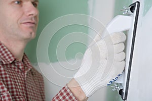 Sanding the drywall mud