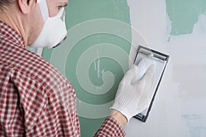 Sanding the drywall mud