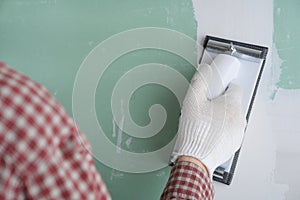 Sanding the drywall mud