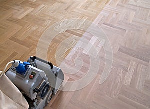 Sanding parquet with the grinding machine photo