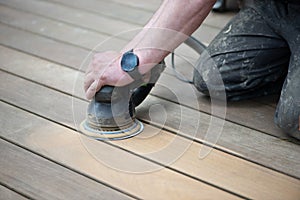 Sanding process of wooden terrace floors. Sanding machine remove imperfections.