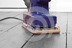 Sanding wood floorboard