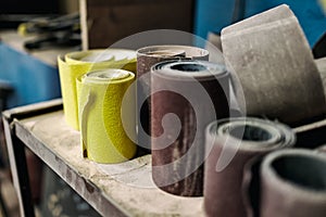 Sandpaper of different color and size on workspace.