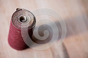 Sandpaper roll on a wooden table