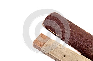 Sandpaper and wood on white background