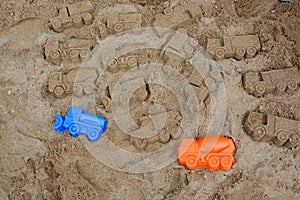 Sandpit, two molds for sand cars and sand cars.