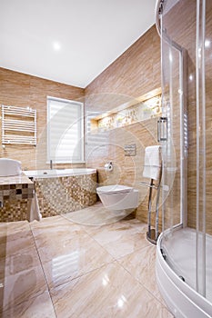 Sandstone bathroom with bath